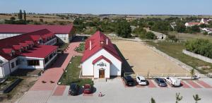 an overhead view of a church with cars parked in a parking lot at TERRA penzión in Jasová