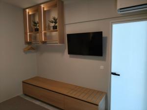 a living room with a tv on a wall at Creta Sky in Achlia