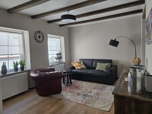 a living room with a couch and a table at Excellent house in Ediger-Eller