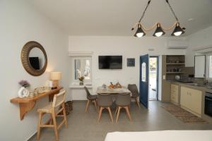 a kitchen and dining room with a table and chairs at Onar Sifnos by the sea in Cherronisos
