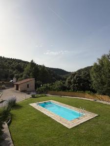 a swimming pool in the middle of a yard at Villa Natalia in Monroyo