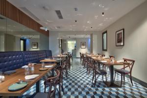 a dining room with wooden tables and chairs at La Falconeria Hotel in Valletta