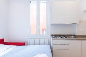 a kitchen with a bed and a sink and a window at Garisenda, Bologna by Short Holidays in Bologna +15 photos