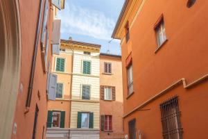 an alley between two buildings in a city at Garisenda, Bologna by Short Holidays in Bologna
