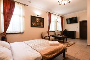a bedroom with a bed and a chair at Dworek Opartowo in Rajgród