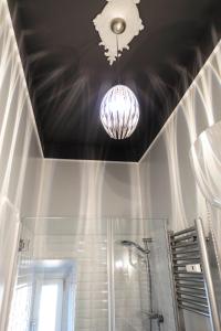 a chandelier hanging from a ceiling in a bathroom at La Rosa del Vaticano Luxury Apartment in Rome