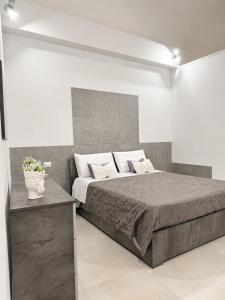 a bedroom with a bed in a white room at Longhome in Pompei