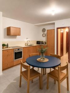a kitchen with a table and chairs in a kitchen at Maison Bruxelles in Brussels