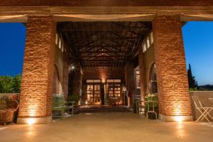 a large brick building with two large brick columns at B&B Tenuta Castello Golf Club in Cerrione