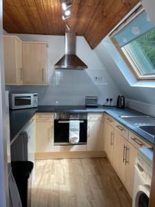a kitchen with a sink and a stove top oven at West Haven Lodge in Aultbea