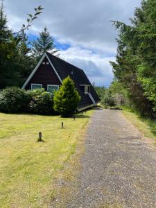 a house on the side of a road at West Haven Lodge in Aultbea