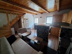 a living room with a couch and a table at Katun Mokra in Podgorica
