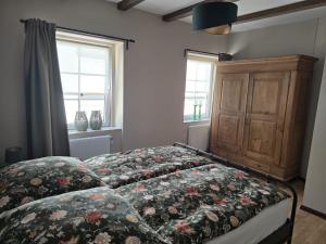 a bedroom with a bed with a floral comforter at Excellent house in Ediger-Eller +71 photos