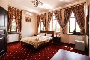 a bedroom with a bed in a room with windows at Dworek Opartowo in Rajgród
