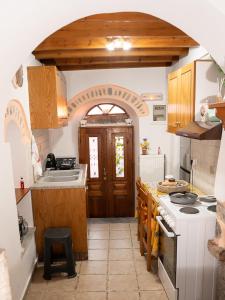 a kitchen with a sink and a stove at Elata Stone Retreat Traditional Village House in Chios