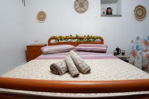 a bedroom with a bed with two towels on it at Elata Stone Retreat Traditional Village House in Chios