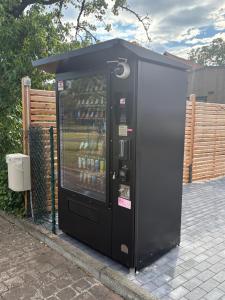 a black vending machine with drinks in it at KE-Tiny-Siedlung Haus Buddy in Oerlenbach
