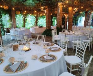 a table set up for a wedding with white tables and chairs at Hotel Sierra Madrona in Fuencaliente +31 photos