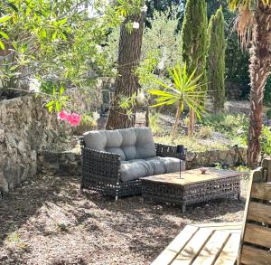 a couch and a coffee table in a yard at Villa Les Lucioles - Chambre indépendante - Piscine privative - Petit déjeuner - Parking in Valbonne +11 photos