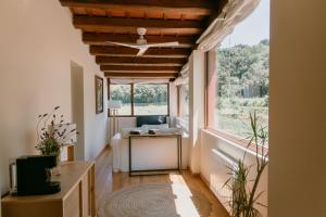 an office with a window and a ceiling fan at Hotel Masia La Palma in Espinavesa