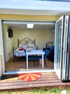 a view of a bedroom with a bed through a sliding glass door at The Witterings Bed and Breakfast in Chichester