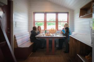 a group of women sitting at a table in a room at Ørsted Outdoor in Lille Ladager