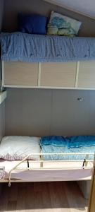 a bunk bed with a mattress and pillows on it at Emeraude aux 1000 Etangs in Belonchamp +24 photos