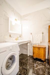 a white laundry room with a sink and a washing machine at B&B Sophia in Santa Sofia dʼEpiro +31 photos