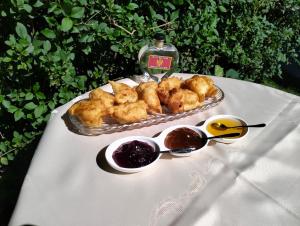 a table with a plate of food and some dipping sauce at RIVERSTONE Drašković camp and bungalows in Nikšić +107 photos