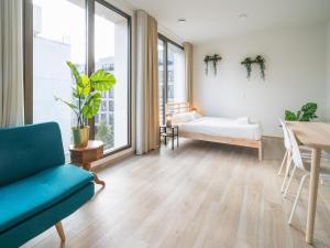 a living room with a couch and a table at City Hideaway with Terrace in Antwerp in Antwerp