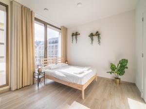a bedroom with a bed and a large window at City Hideaway with Terrace in Antwerp in Antwerp +85 photos