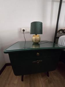 a green dresser with a lamp on top of it at Excellent house in Ediger-Eller
