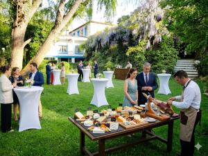 a group of people standing around a table with food at Hotel Sierra Madrona in Fuencaliente