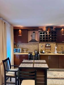 a kitchen with wooden cabinets and a table and chairs at Flat in Leskovik in Leskovik