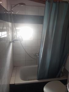 a bathroom with a shower with a tub and a toilet at Ελένη in Iraklitsa +30 photos