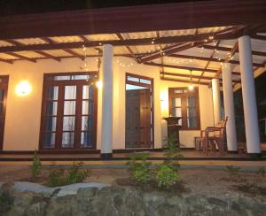 a porch of a house at night at NIVRA Homestay in Kumbalwela