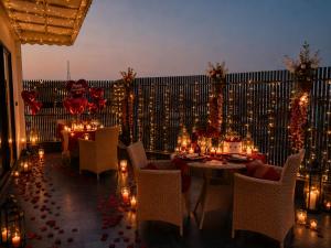 a room with tables and chairs with candles and lights at Classic Hotel in Pānīpat