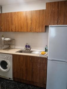 a kitchen with a white refrigerator and a sink at City Centre Room Near Everything in Varna City +9 photos