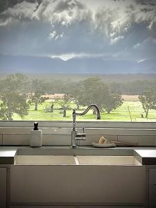 a kitchen sink with a view of a window at Bunnugal House in Dunkeld