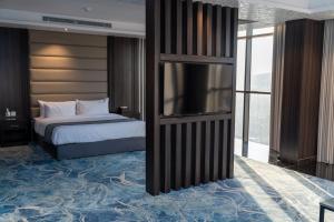 a bedroom with a bed and a tv in it at فندق ديماس DEMAS Hotel in Khamis Mushayt +9 photos