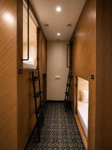 a small room with a bed and two bunk beds at Nathan's Residency in Tiruchirappalli +18 photos