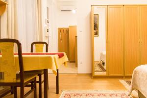 a dining room with a table and a mirror at Authentic Klauzal Apartment in Budapest