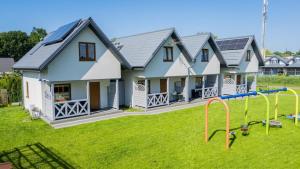 a house with a playground in the yard at Domki u Basi - 250m do Plaży - Idealne dla Rodzin in Karwia +30 photos