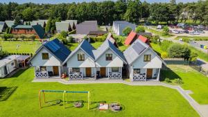 an aerial view of a house with a playground at Domki u Basi - 250m do Plaży - Idealne dla Rodzin in Karwia