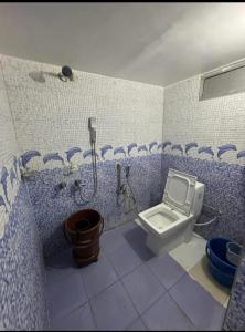 a bathroom with a toilet and a shower in it at RAMRAJ GUEST House in Ayodhya