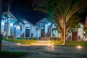 a building with stairs and a palm tree at night at Breeze 12 Villa in Negombo