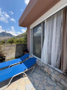 a blue bench on the balcony of a house at Blue Days Villa 2 in Shkalle Stenojt