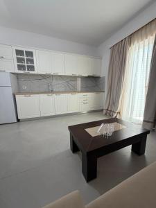 a living room with a coffee table and white cabinets at Blue Days Villa 2 in Shkalle Stenojt