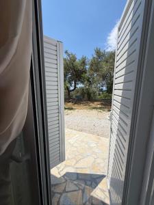 an open door to a patio outside of a house at Blue Days Villa 2 in Shkalle Stenojt