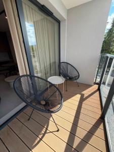 two chairs and a table on a balcony at MJ Apartments in Łomża